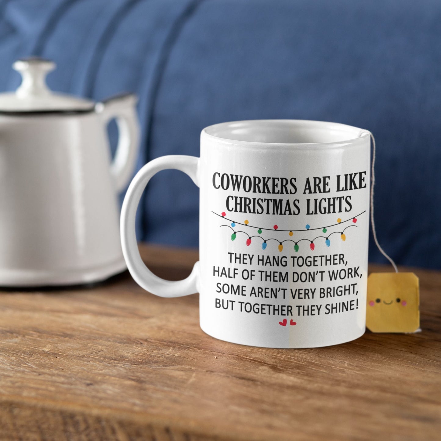 Funny Office Coffee Mug 11oz on a wooden table with a tea bag, showcasing the humorous design that brings joy to any office environment.