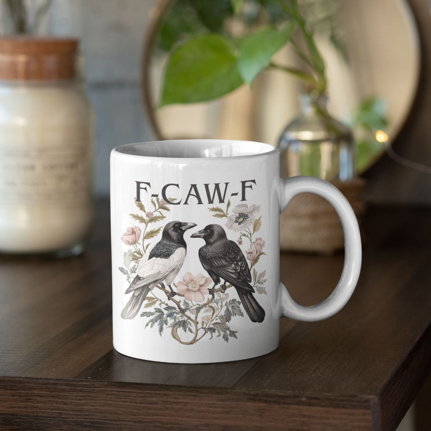 Funny Swear Words F Caw Halloween Mug held by a person, showcasing the playful crow design. A fun gothic coffee cup that’s great for gifts or personal use.