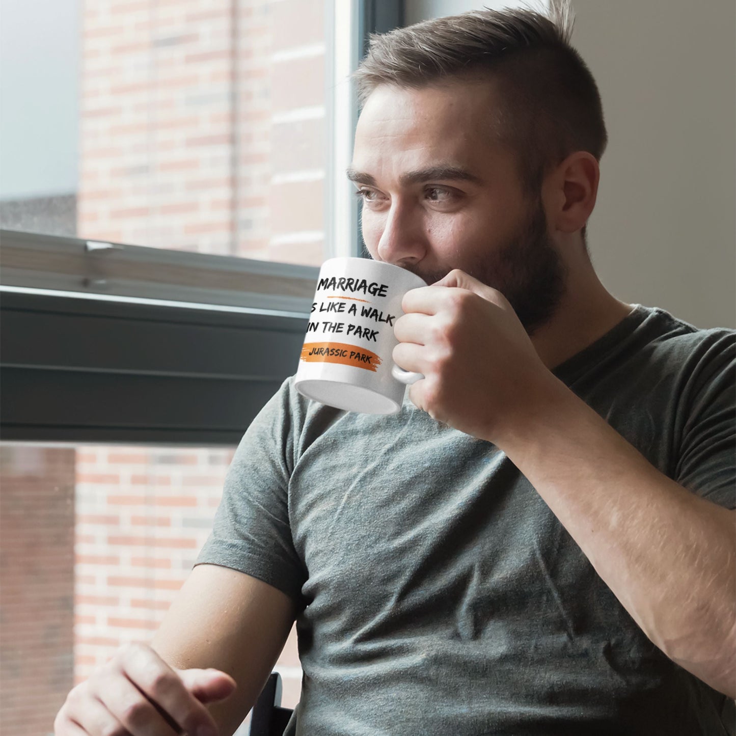 Funny 11oz Ceramic Coffee Mug with the humorous text 'Marriage is like a walk in the park, Jurassic Park' being enjoyed by a man, ideal for joke gifts for men.