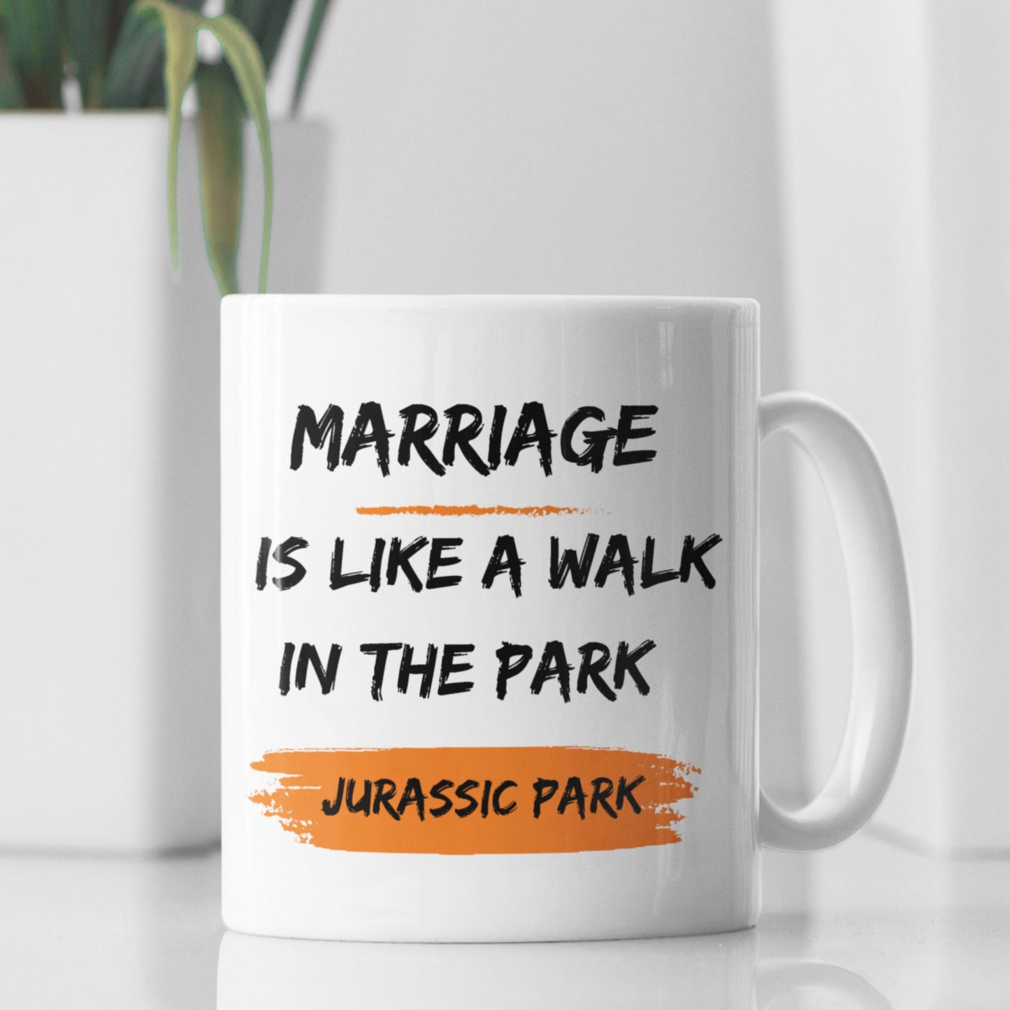 Funny 11oz Ceramic Coffee Mug in a styled setting, showcasing the phrase 'Marriage is like a walk in the park, Jurassic Park' - a humorous option for joke gifts for men.