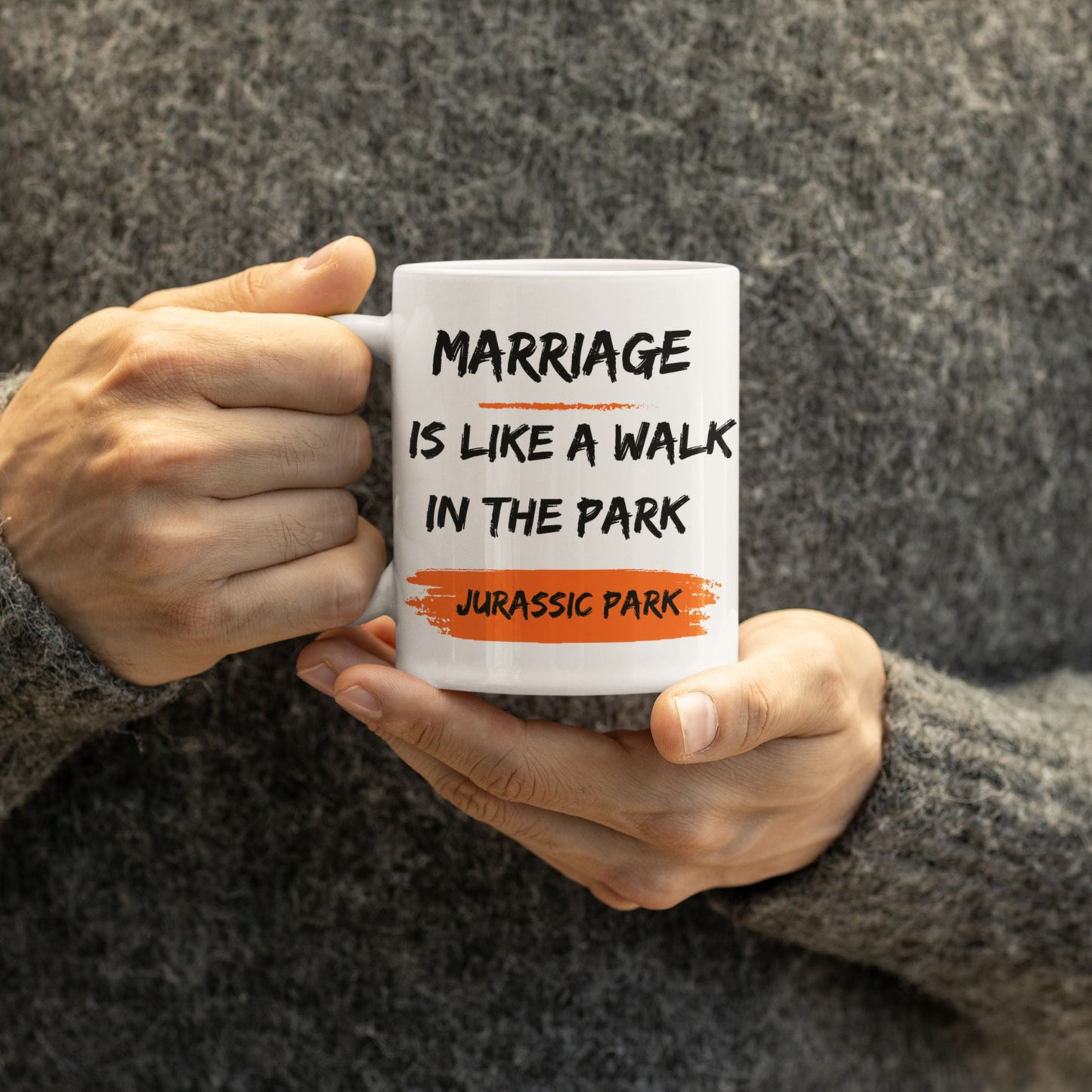 Close-up of a person enjoying a Funny 11oz Ceramic Coffee Mug with the saying 'Marriage is like a walk in the park, Jurassic Park', an excellent option for joke gifts for men.