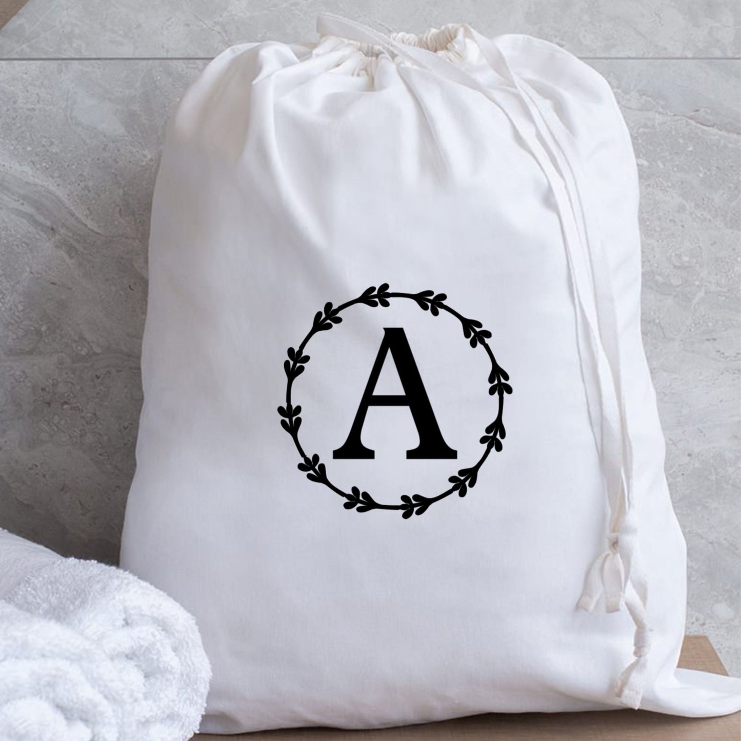 Eco-friendly monogrammed laundry bag with drawstring closure, perfect gift for students and new roommates.