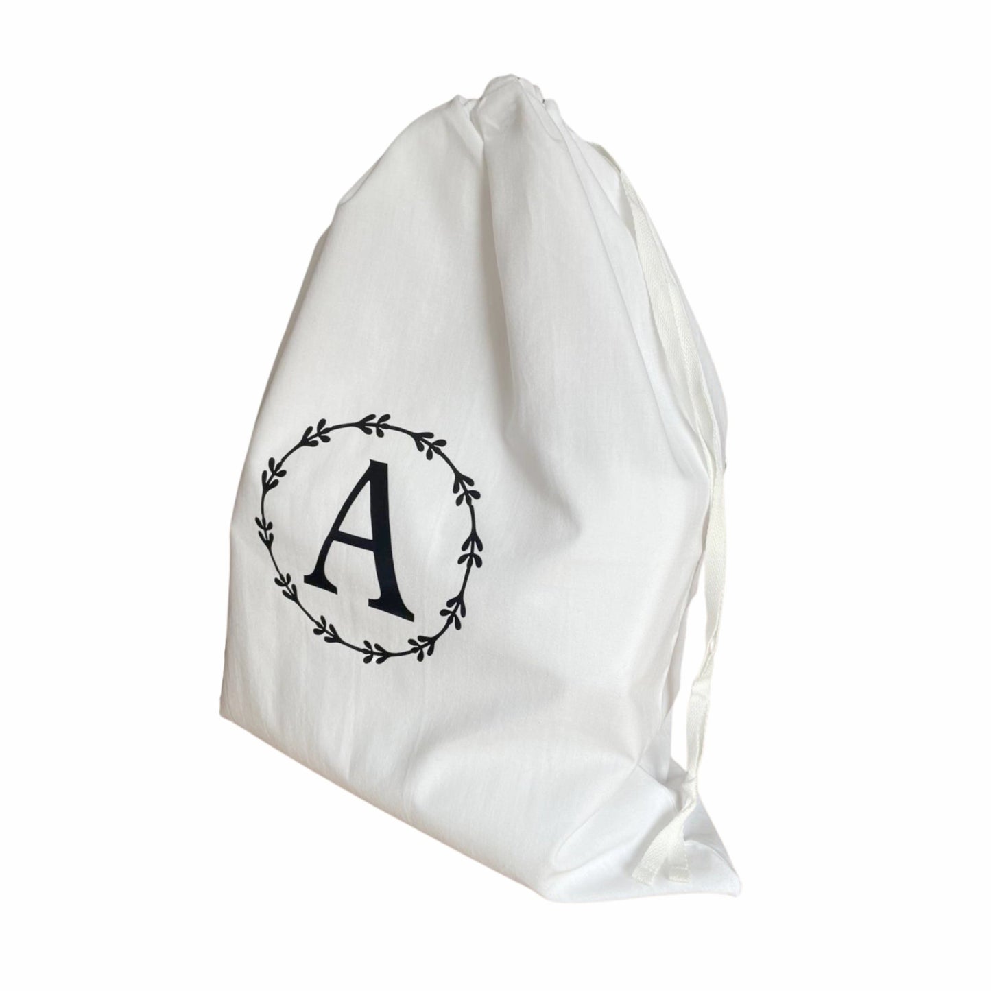 Trendy monogrammed laundry bag made from breathable cotton, ideal for practical and stylish laundry organization.