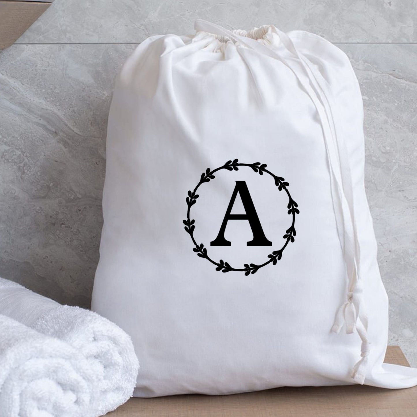 Classic white monogrammed laundry bag measuring 53 x 44 cm, perfect for stylish organization in dorm rooms.