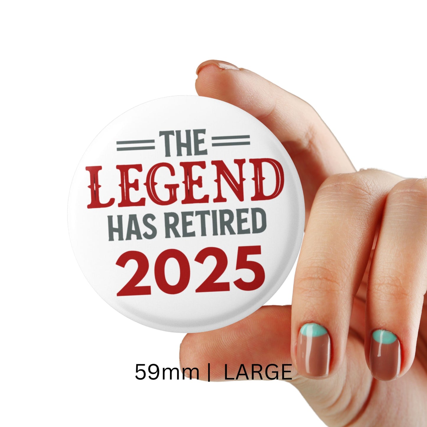 A hand showcasing the large 59mm Retirement Badges 2025 pin, printed with 'The Legend Has Retired 2025'.