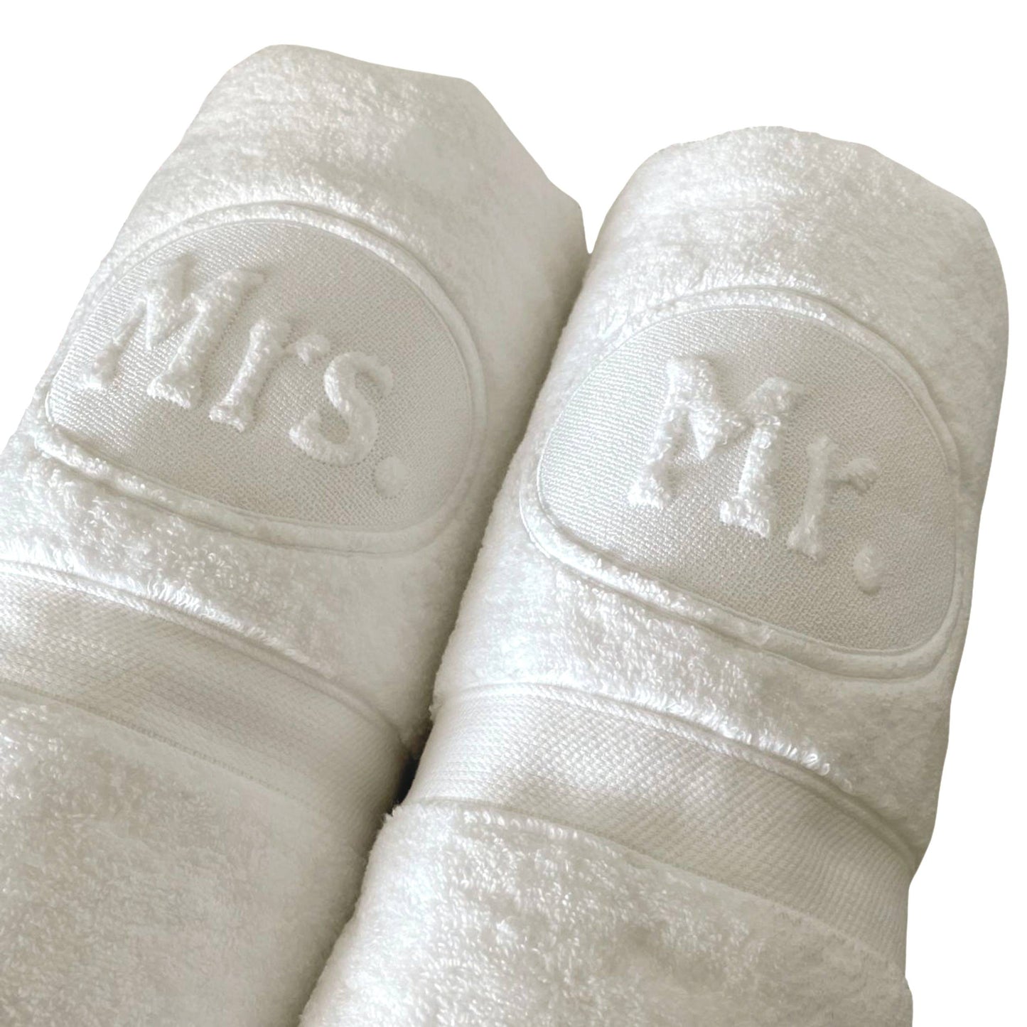 Two rolls of white toilet paper, one labeled 'Mr.' and the other 'Mrs.', on a white background.