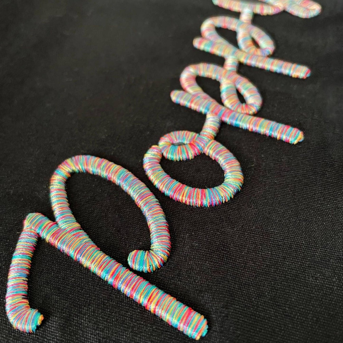 A collection of personalized custom drawstring bags with unique 3D puff embroidery designs.