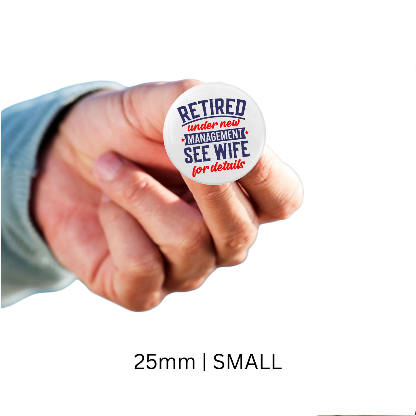 Retirement Badges: Heartfelt Thank You Gifts for Men - A small hand holding a 25mm badge with 'Retired under new management, see wife for details' - Thoughtful farewell gift ideas for colleagues.