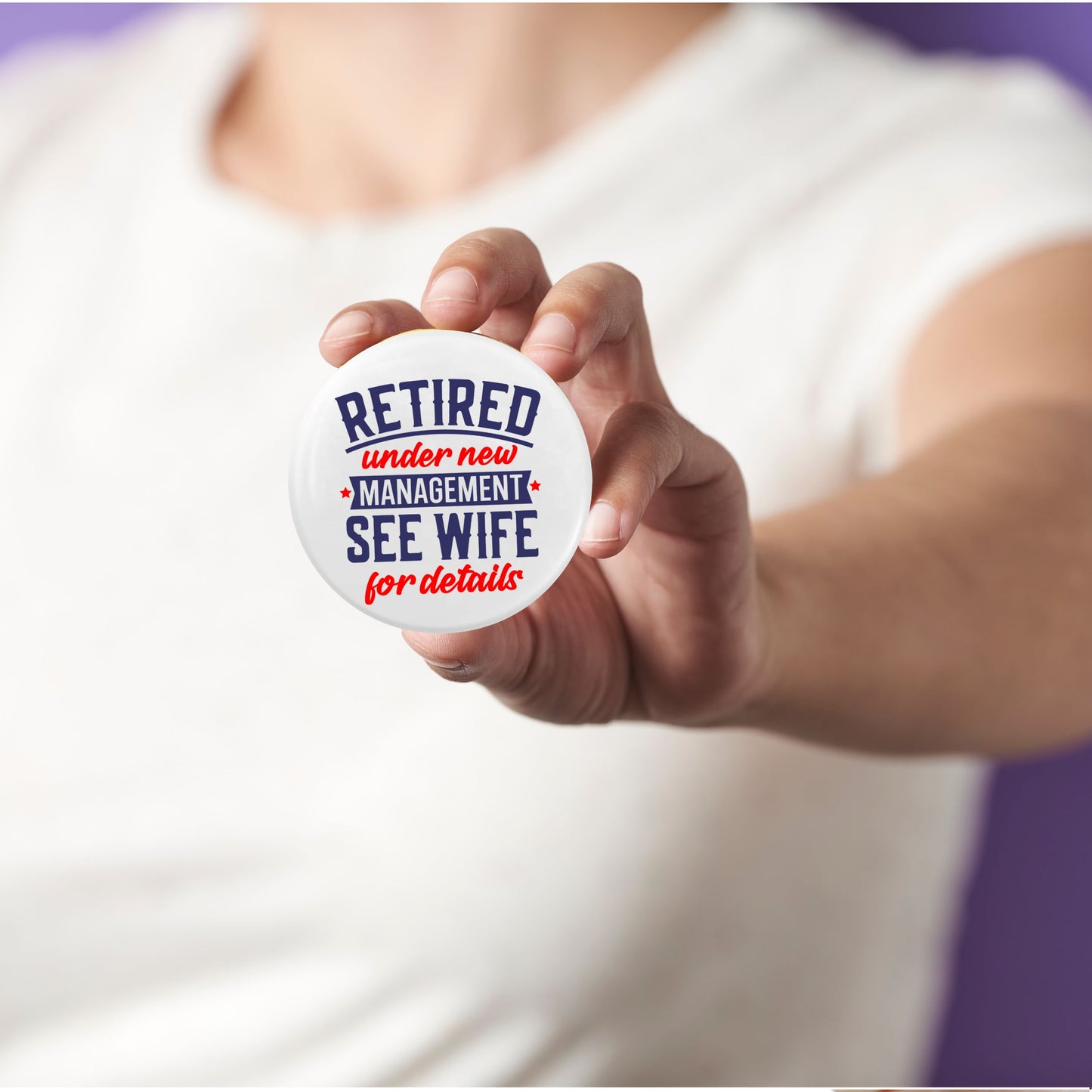 Retirement Badges: Heartfelt Thank You Gifts for Men - A person holding a badge that says 'Retired under new management, see wife for details' - Creative farewell gift ideas for colleagues.
