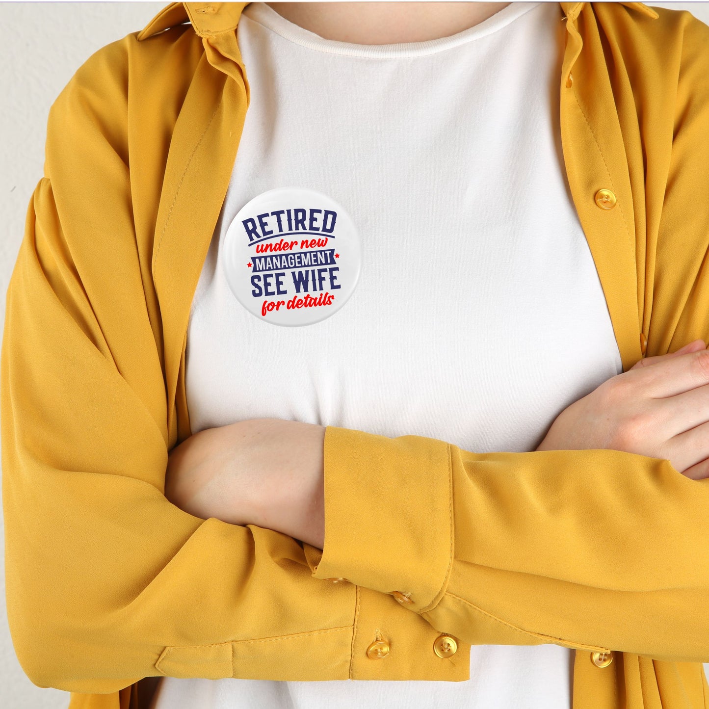 Retirement Badges: Heartfelt Thank You Gifts for Men - Person in a yellow shirt with a badge showing 'Retired under new management, see wife for details' - Perfect farewell gift ideas for colleagues.