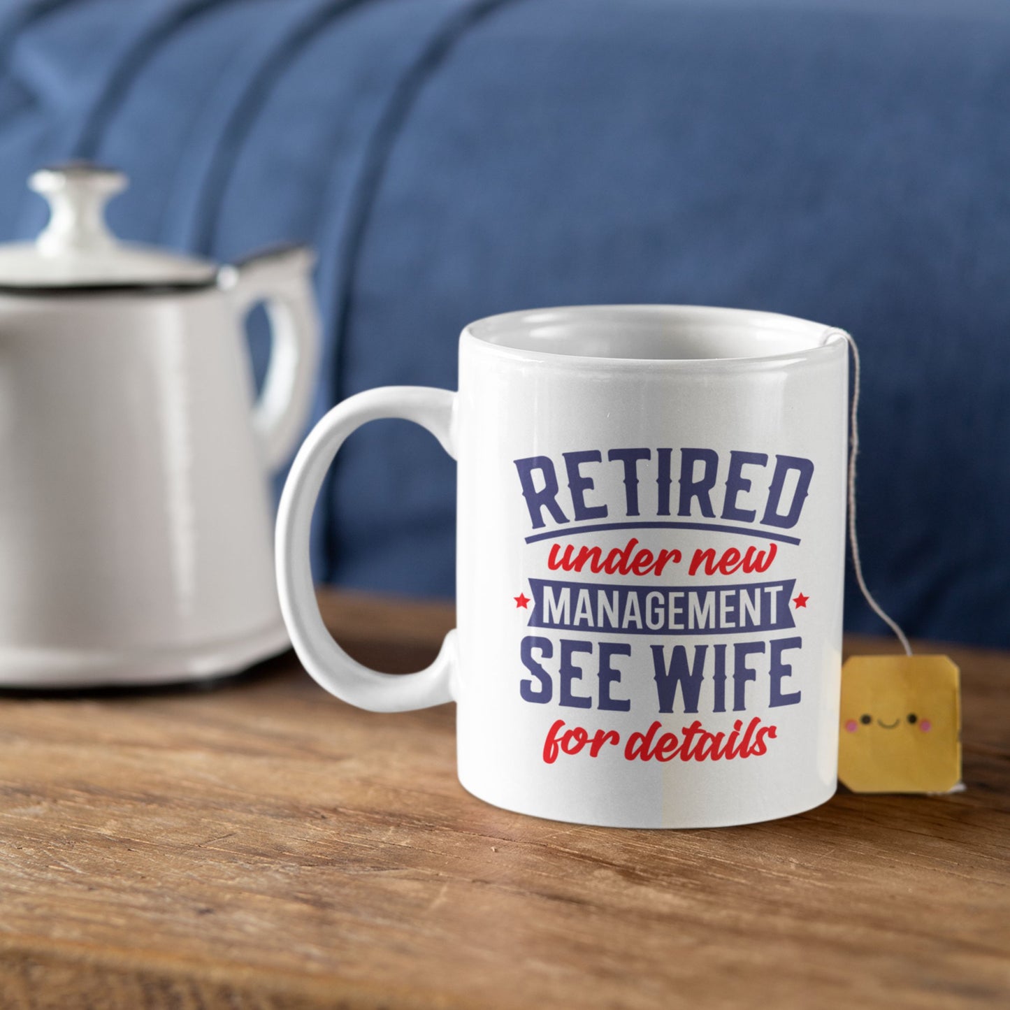 Happy Retirement Coffee Mug 2025 with a teabag nearby, a cheerful gift option for retiring colleagues.