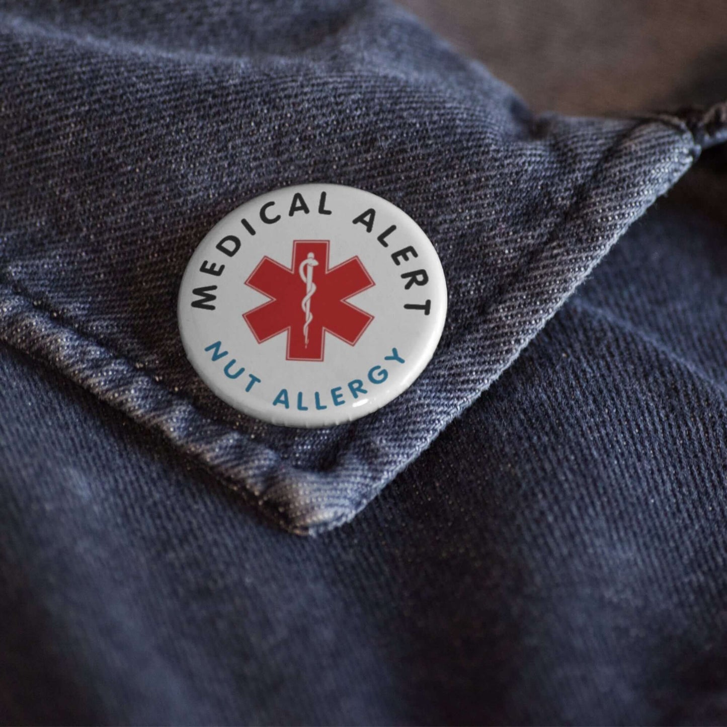 Nut Allergy Awareness Badge - 1 Inch Medical Alert Logo Pin displayed on a denim shirt to promote nut allergy awareness.