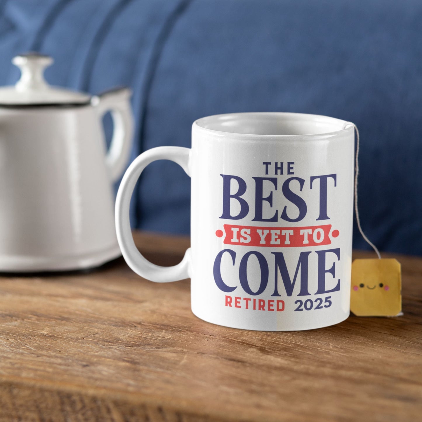 Happy Retirement Coffee Mug 2025 on a wooden table next to a teapot, featuring 'The Best Is Yet To Come Retired 2025' - a stylish retirement coffee mug.