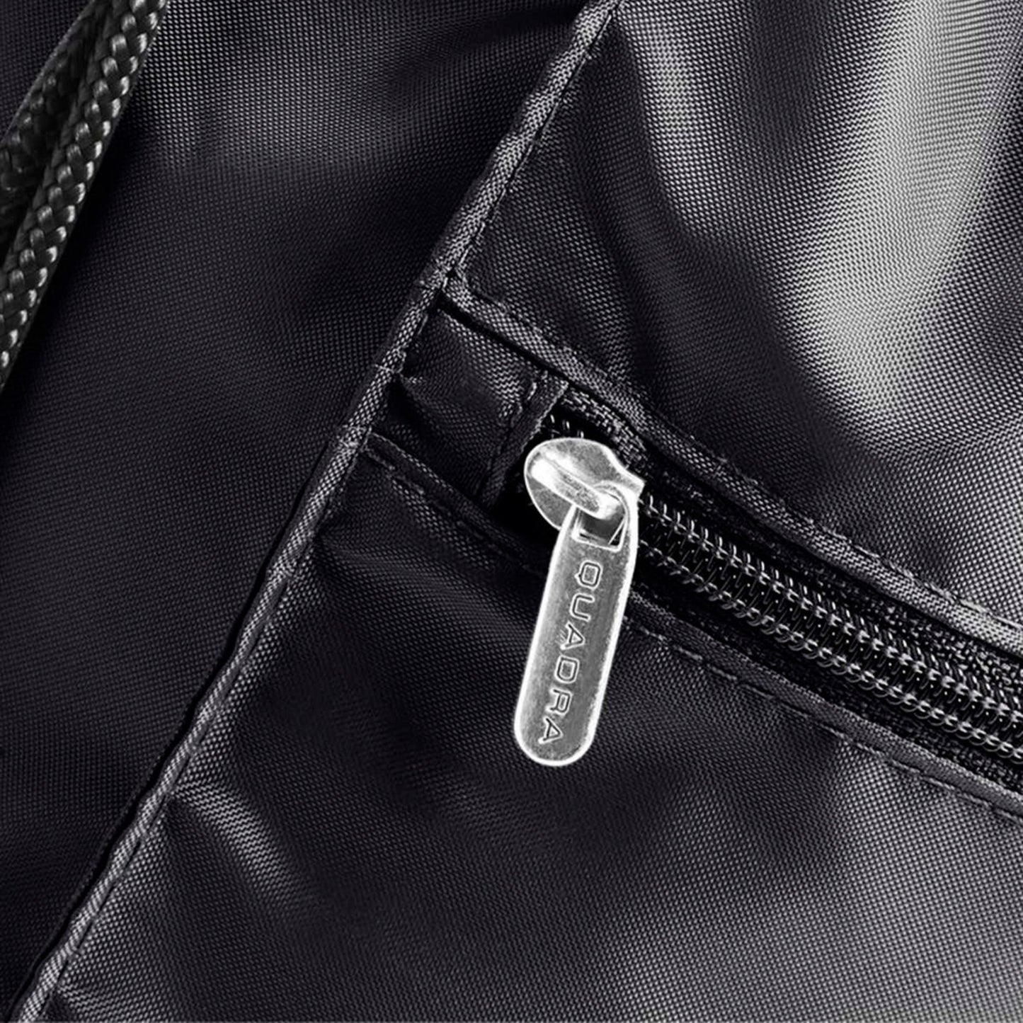Close-up of a black backpack zipper with a brand logo.
