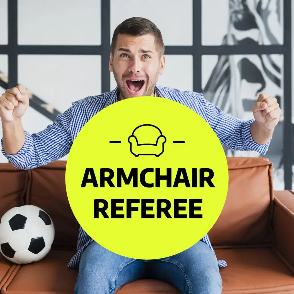 Excited fan wearing a Funny Football Badge titled 'Armchair Referee', showcasing enthusiasm for football.