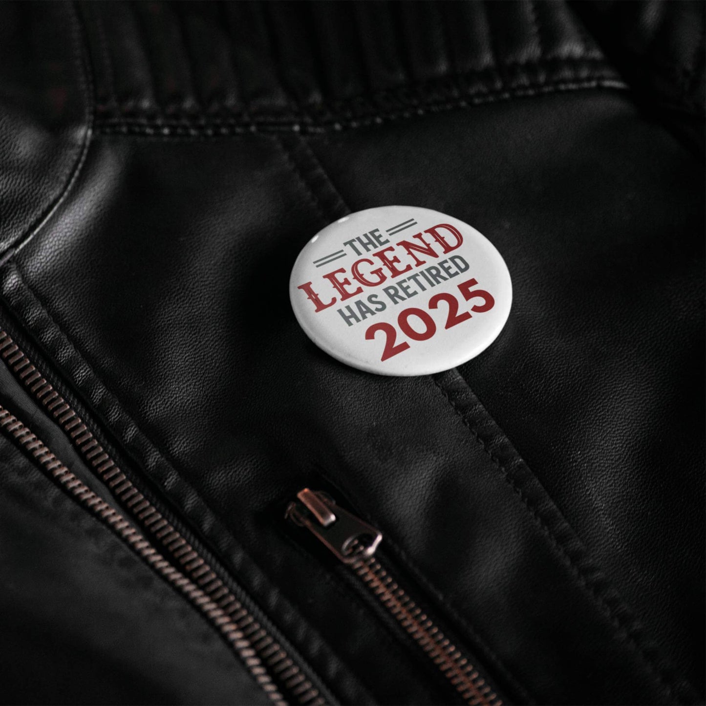 Close-up of the Retirement Badges 2025 pin on a leather jacket, demonstrating its stylish appeal.