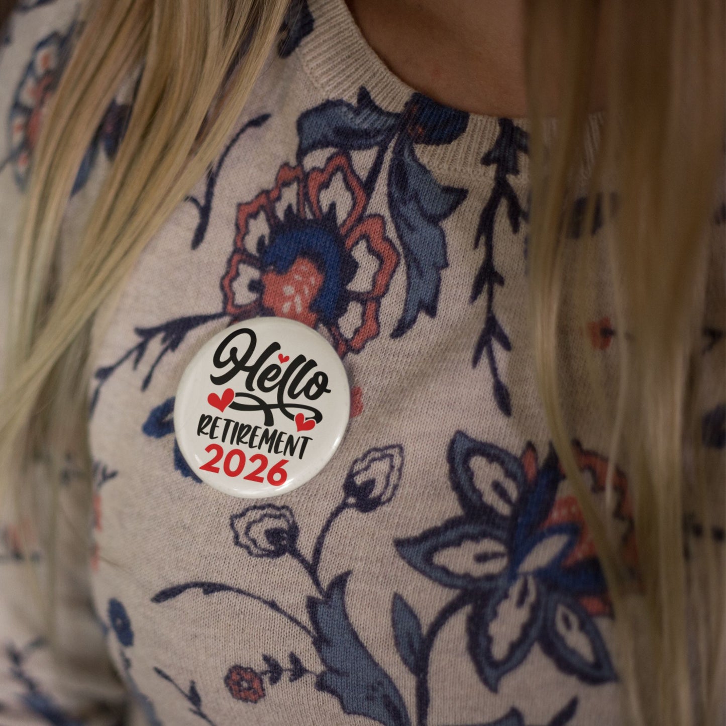 Close-up of the Hello Retirement 2026 Badge – Funny Retirement Gift Pin Button on a patterned sweater, perfect for celebration.