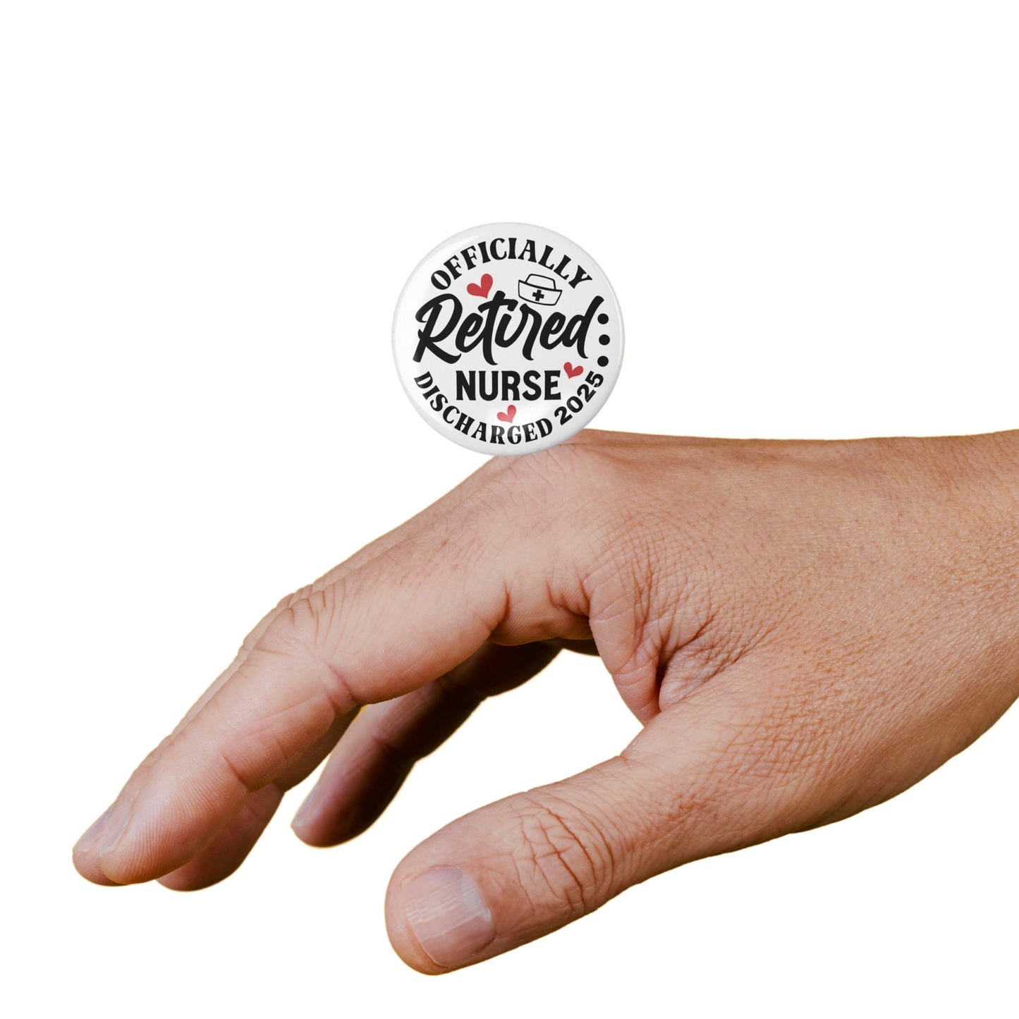 A hand holding the Retired Nurse Badge - Officially Retired 1 Inch Health Awareness Pin Button Badge, showing its compact size and design.
