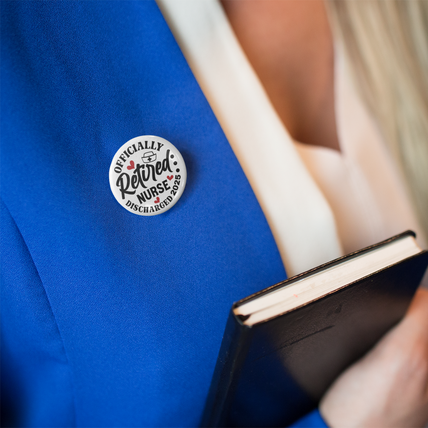 Retired Nurse Badge - Officially Retired 1 Inch Health Awareness Pin Button Badge styled on a smart jacket, perfect for formal settings.