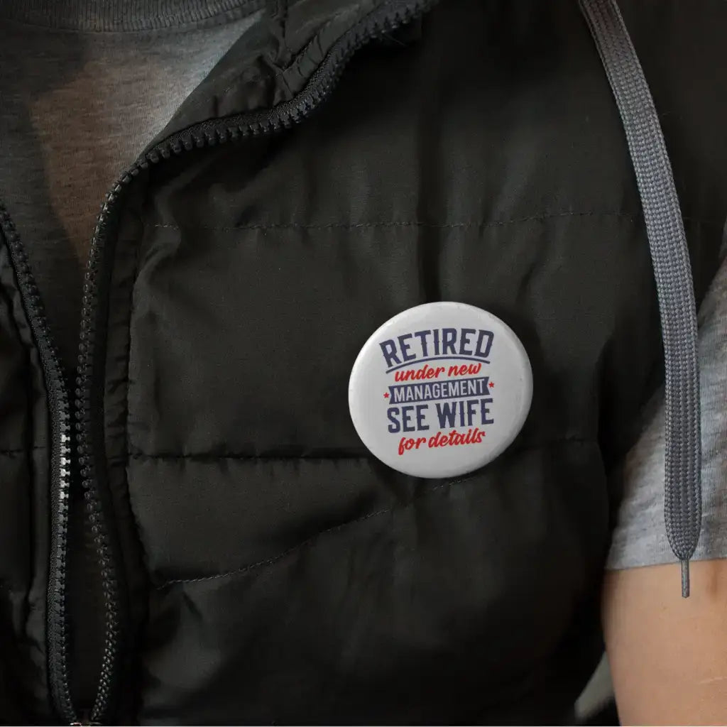 Retirement Badges: Heartfelt Thank You Gifts for Men - A badge displayed on a vest featuring 'Retired under new management, see wife for details' - Clever farewell gift ideas for colleagues.