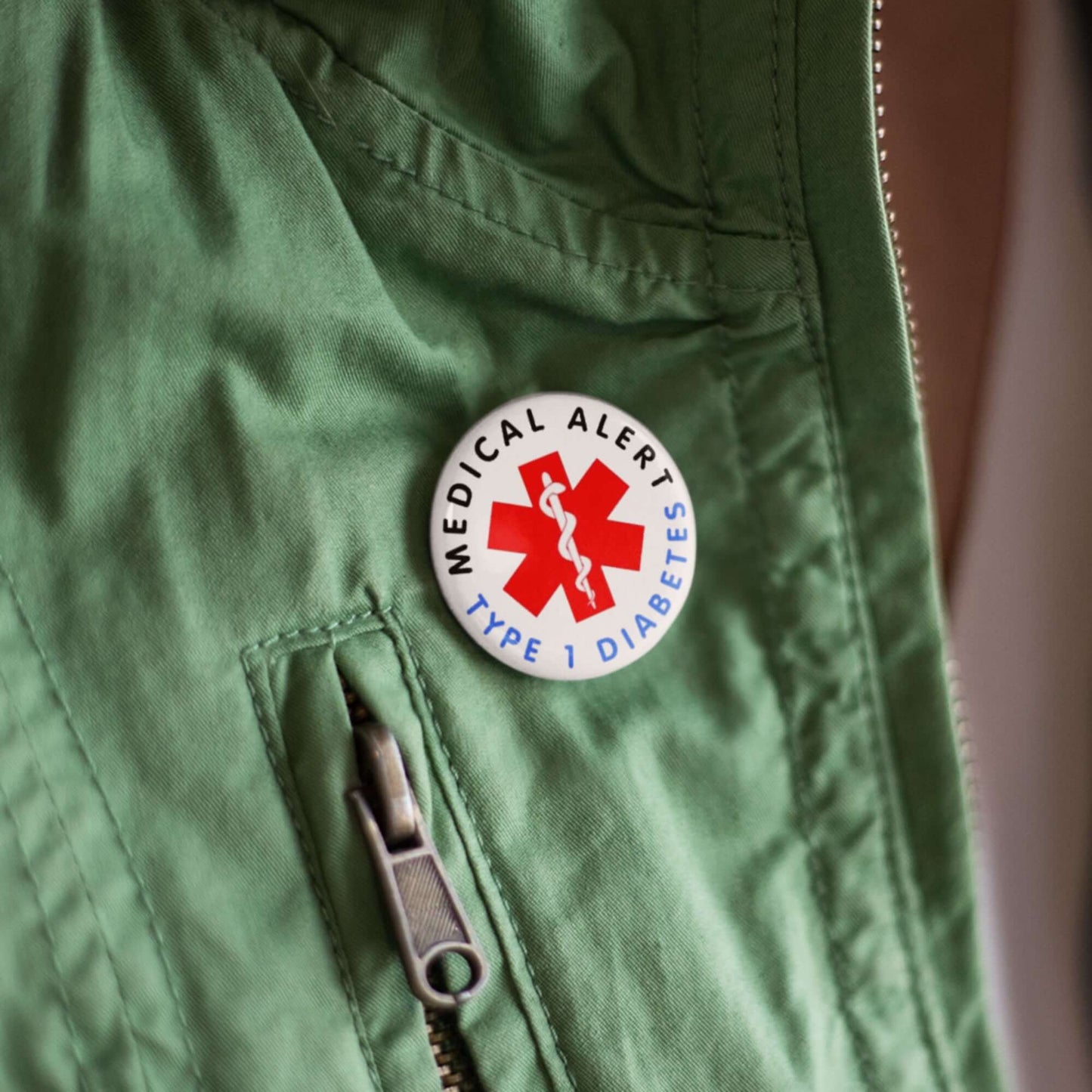 Type 1 Diabetes Safety Item - 25mm Medical Alert Badge attached to a green jacket, ready to provide immediate identification in emergencies.