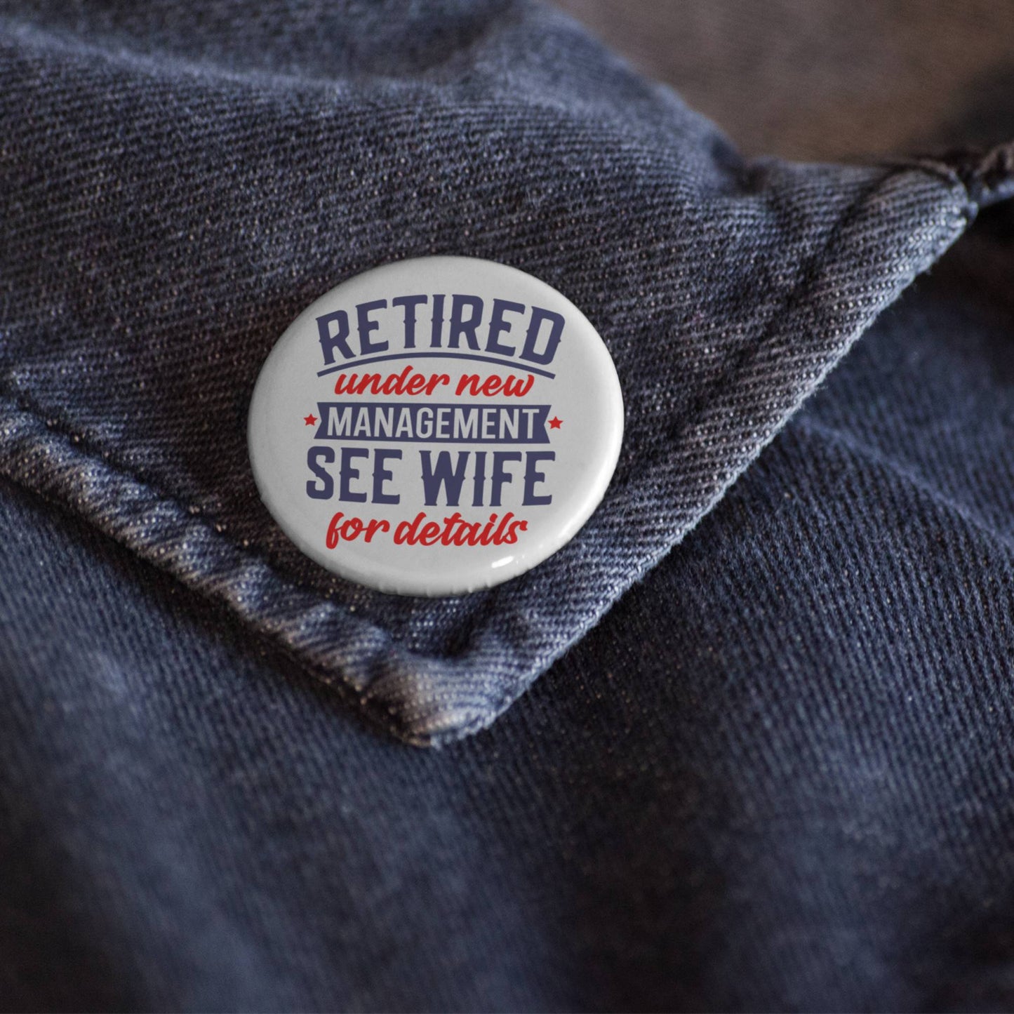 Retirement Badges: Heartfelt Thank You Gifts for Men - A close-up of a badge on denim, stating 'Retired under new management, see wife for details' - Thought-provoking farewell gift ideas for colleagues.