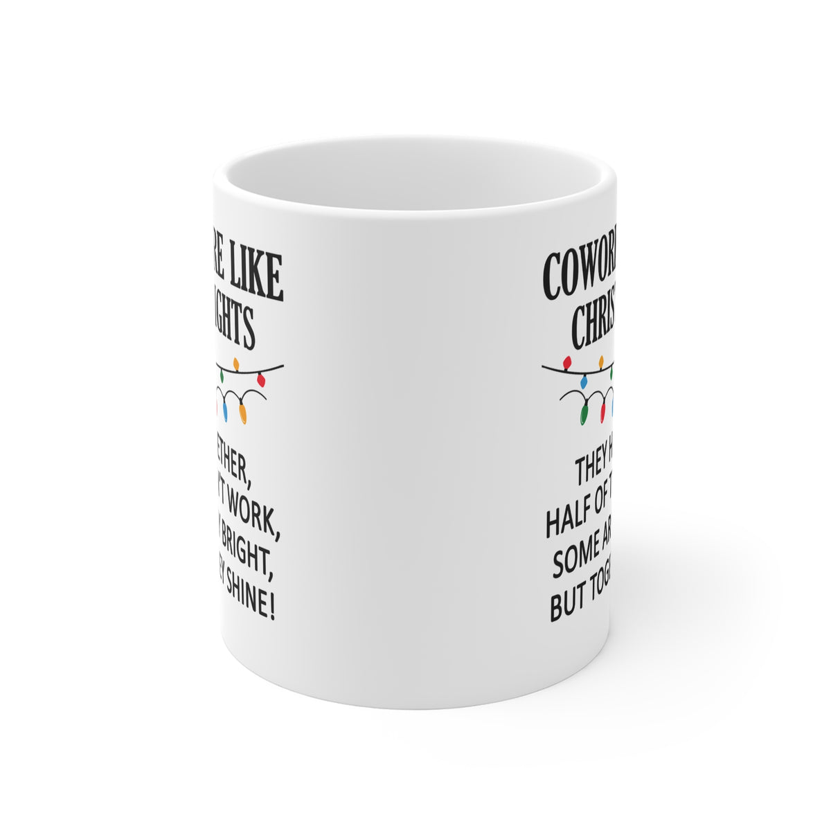 A white ceramic mug with black text and a small multicolor Christmas string lights graphic, shown on a clean white background.