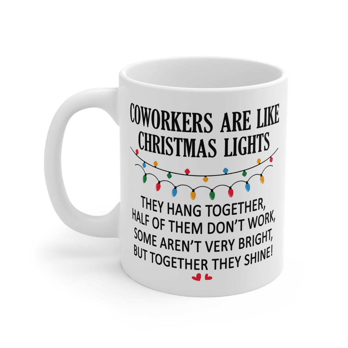 A white ceramic mug with a black printed humorous quote about coworkers and Christmas lights, shown on a clean white background.