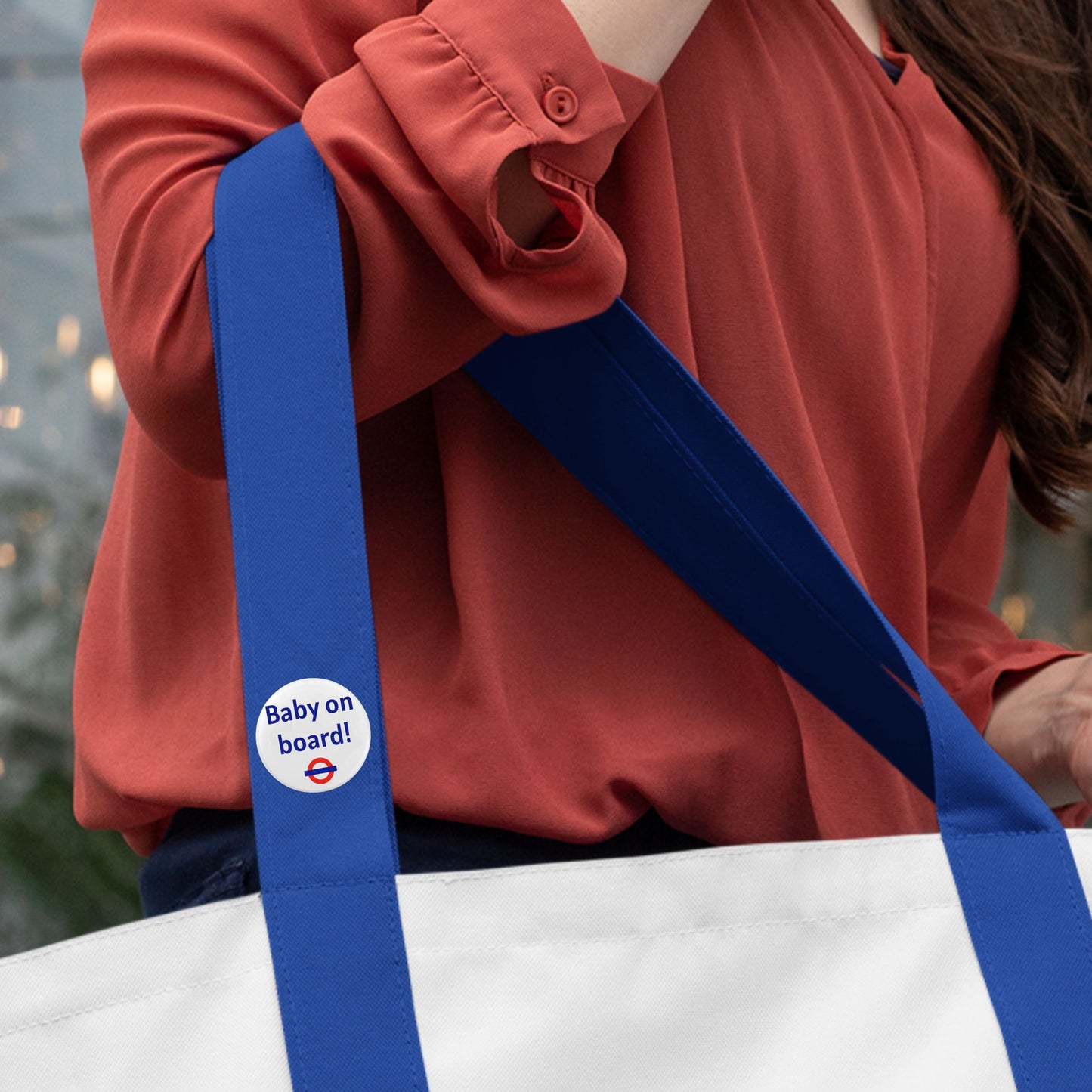 The Baby On Board Badge – London Underground Style Pregnancy Badge prominently displayed on a tote bag, making travel easier for pregnant women.