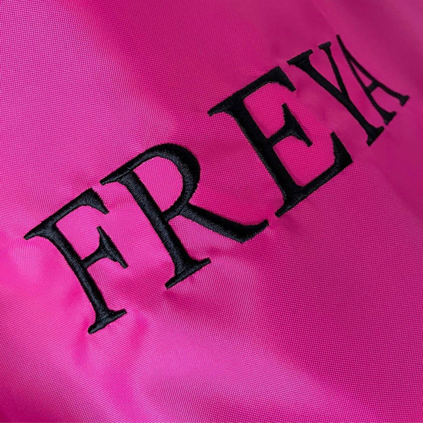 Black 'FREYA' text on a pink background