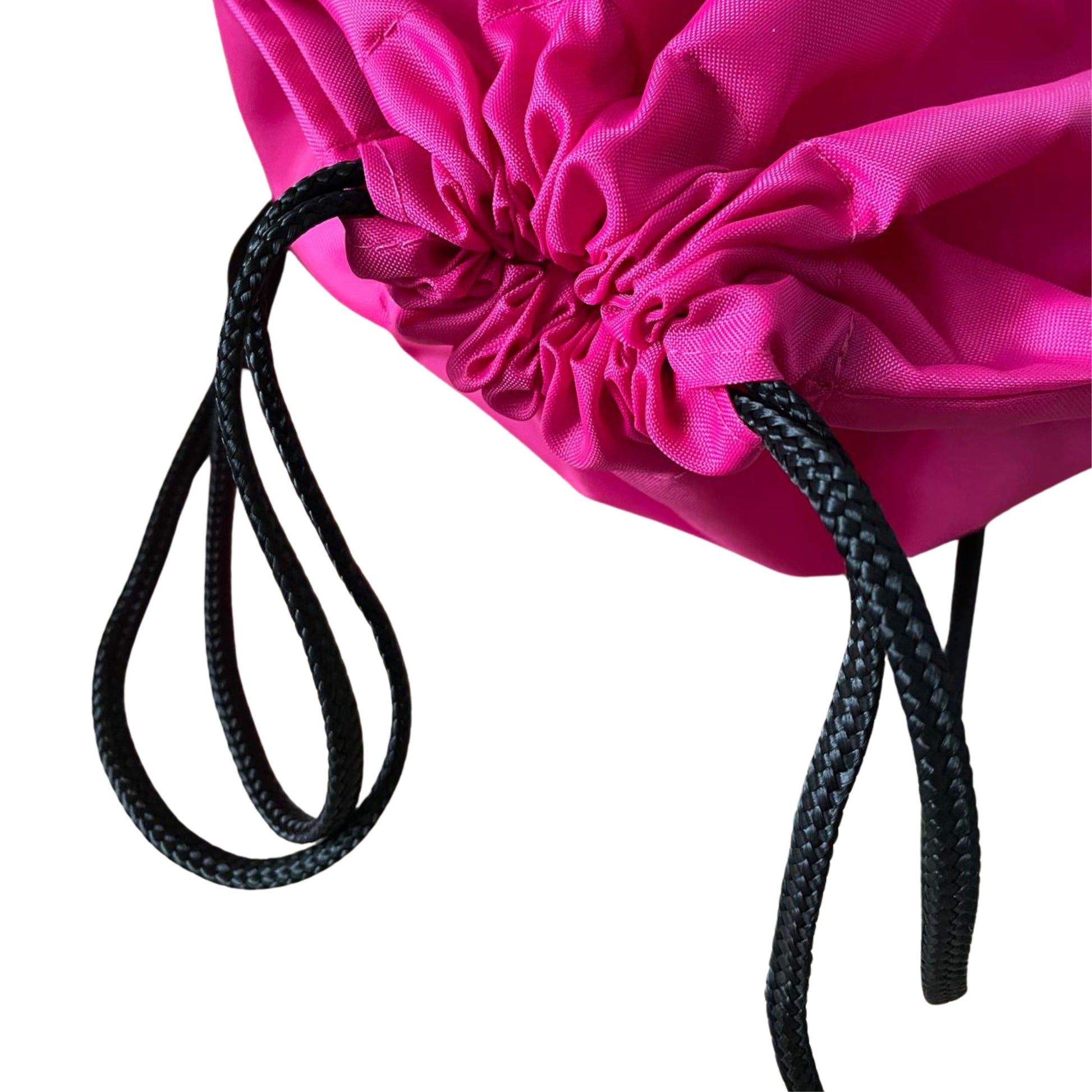 Close-up of a pink drawstring bag with black strings on a white background