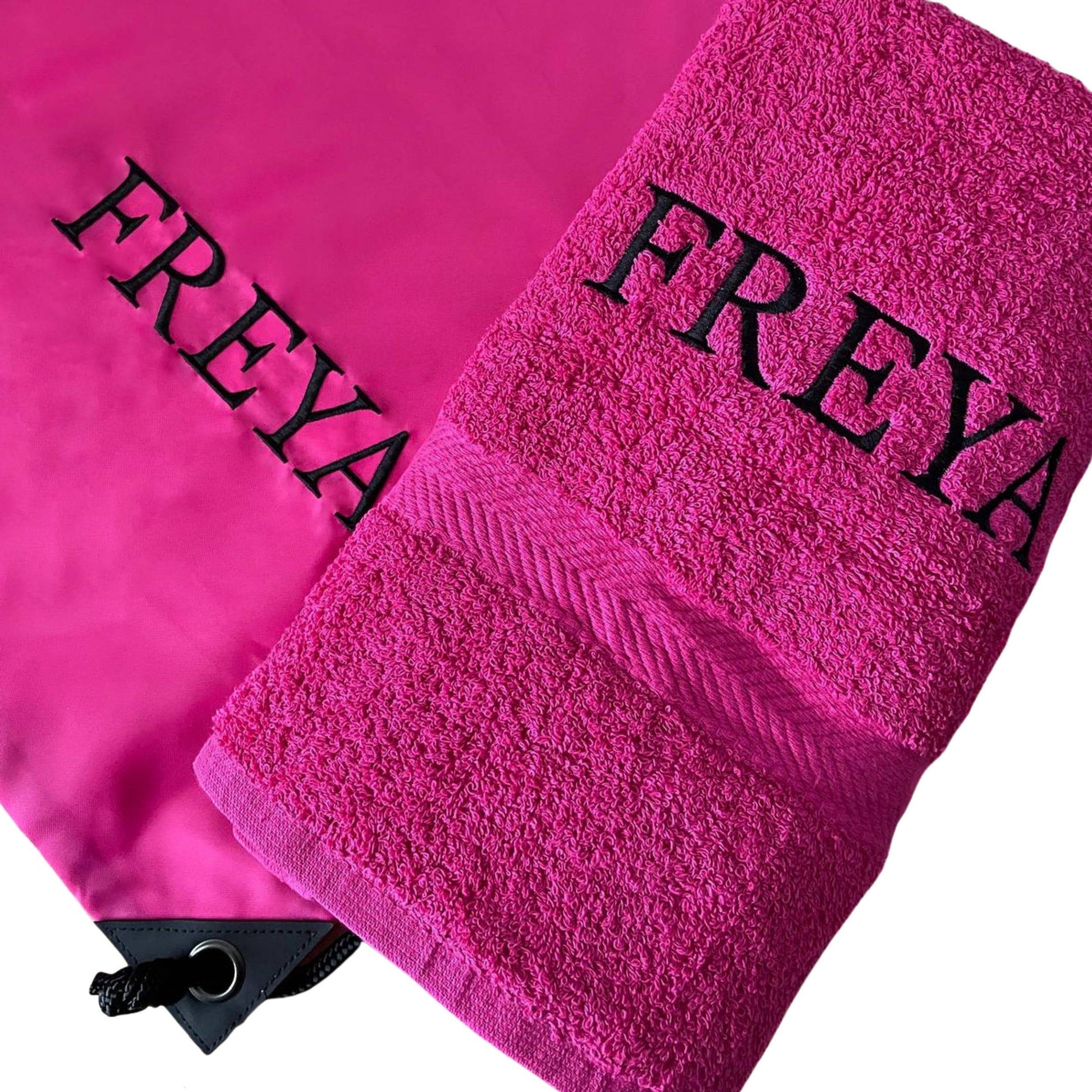 Two pink towels with 'FREYA' branding on a white background