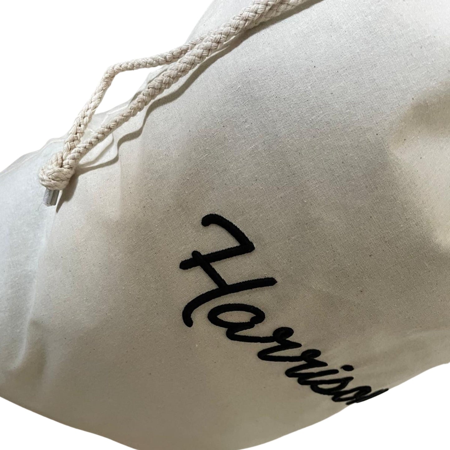 Beige drawstring bag with 'Harrisson' branding on a white background