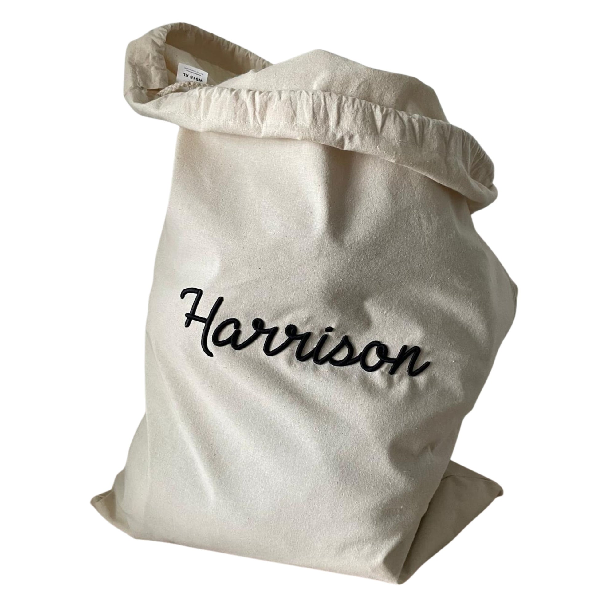 Beige bag with 'Harrison' embroidered on it against a white background