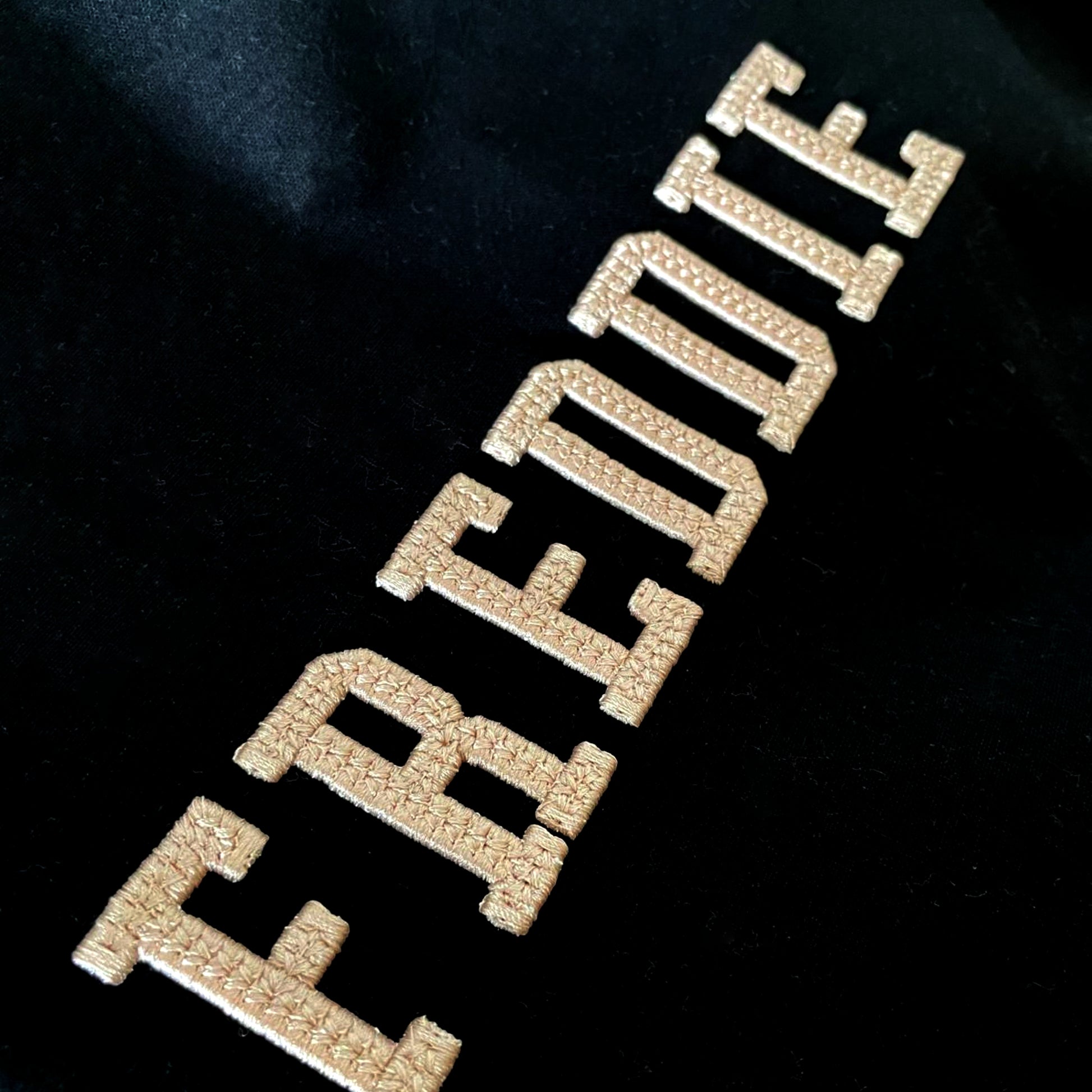 Gold 'FREEDOM' text on a black background