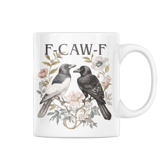 Funny Swear Words F Caw Halloween Mug 11oz glossy ceramic featuring two crows surrounded by floral elements. This humorous gothic coffee cup adds charm to your dark aesthetic.