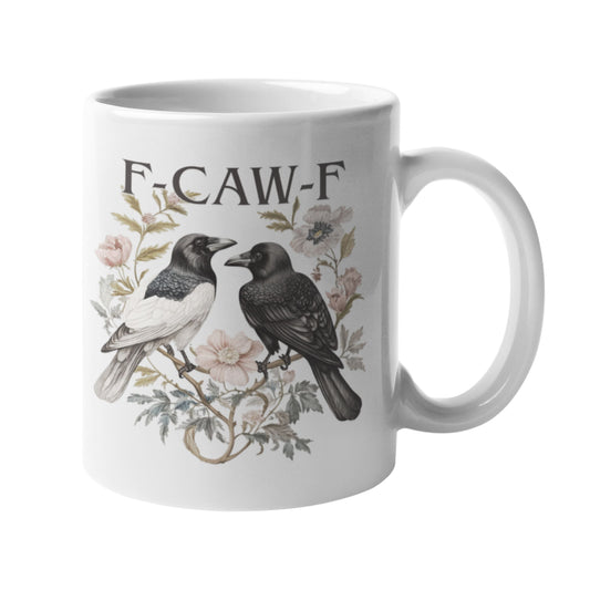 Funny Swear Words F Caw Halloween Mug shown from the side, with a striking design of two crows and floral accents. Perfect as a gothic coffee cup for adding a cheeky twist to your mornings.