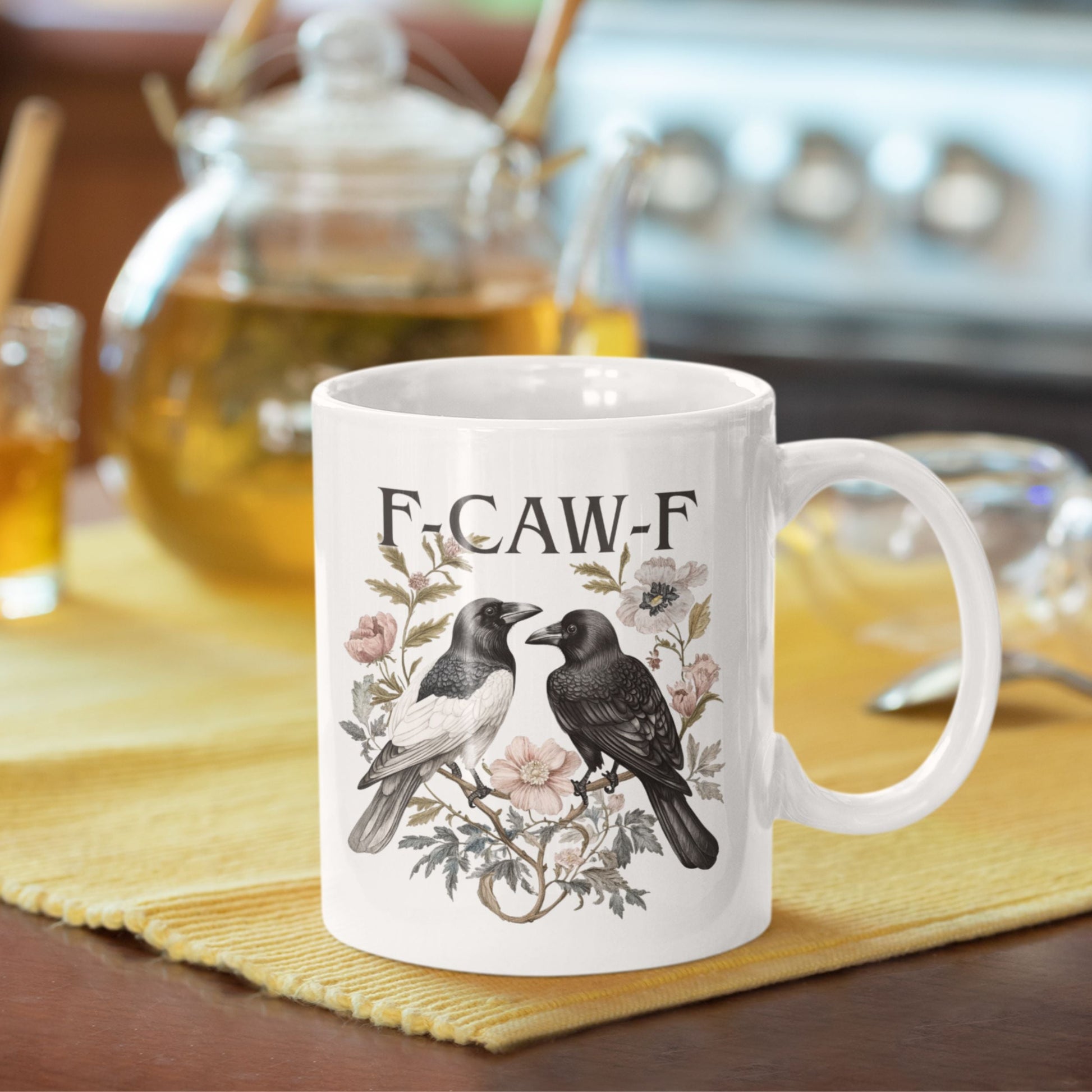 Funny Swear Words F Caw Halloween Mug set against a minimalistic background. A trendy gothic coffee cup that combines humour with artistic design.