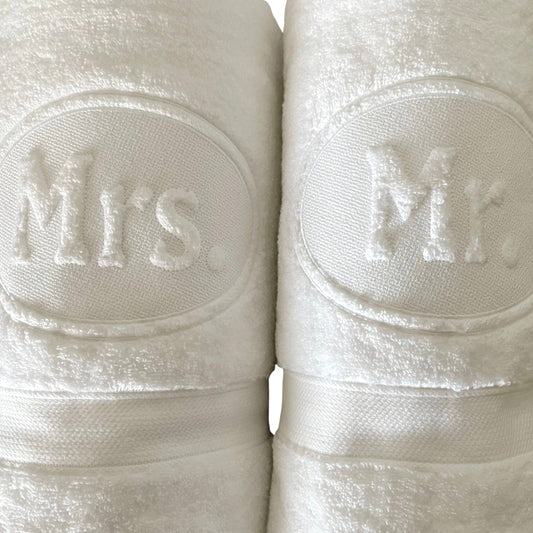 Two rolls of white ribbon with 'Mr.' and 'Mrs.' embossed on them.