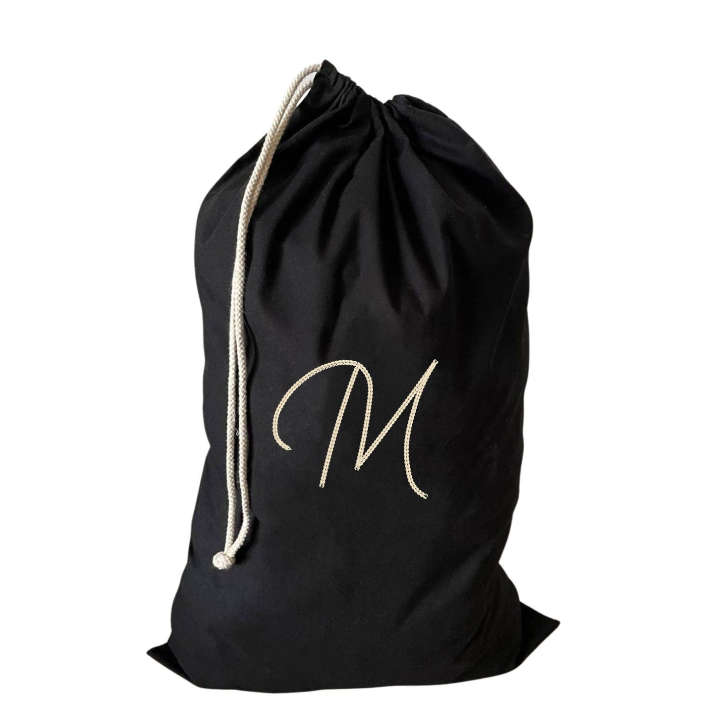 Functional large drawstring laundry bag with an embroidered M, combines style and sustainability.