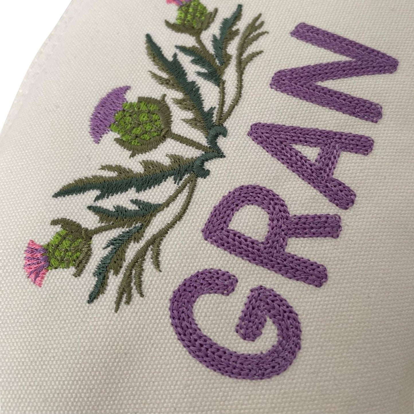 Close-up of Custom Scottish Thistle Gift Zipper Pouch embroidered with 'GRAN'. A charming Scottish thistle gift perfect for grandmothers.