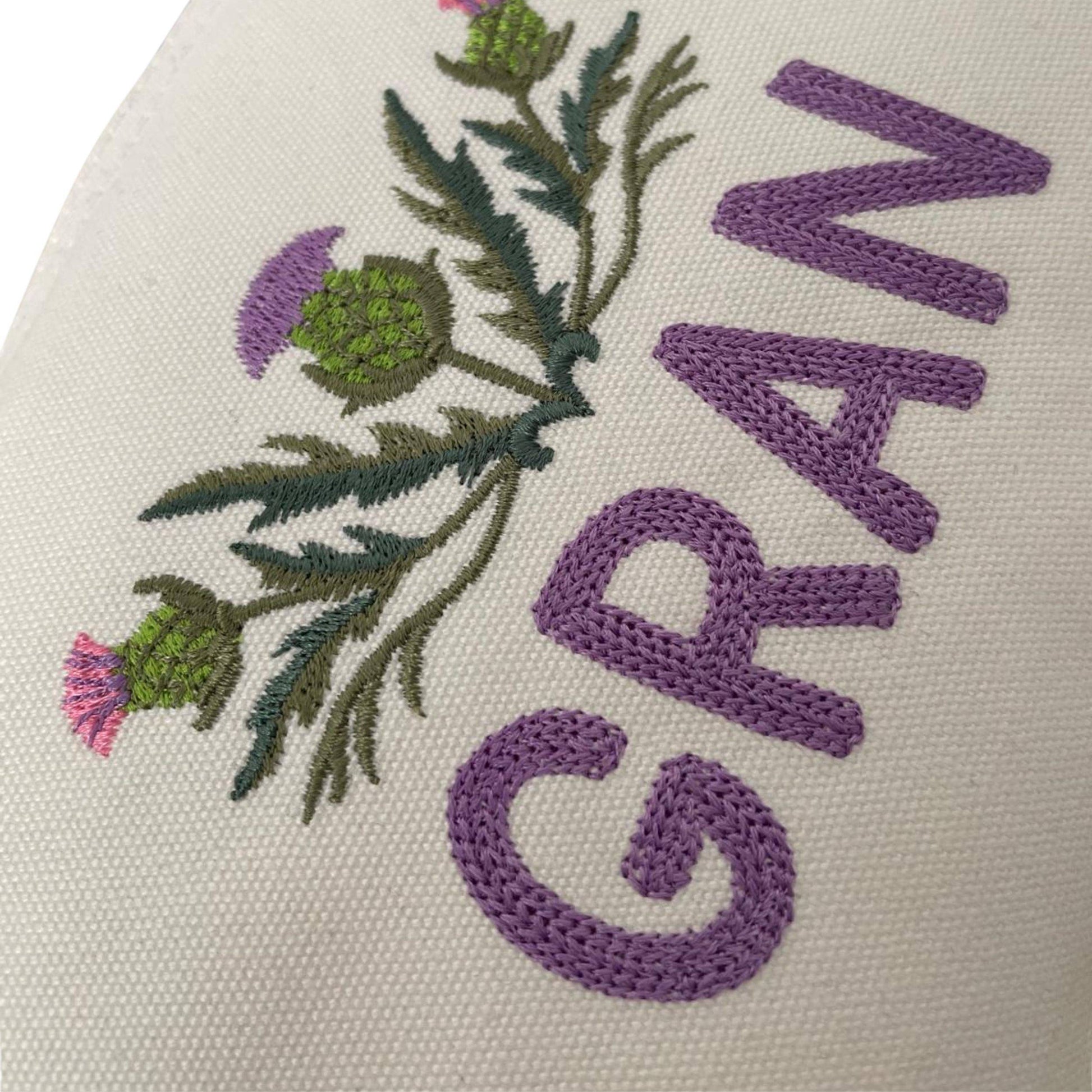 Close-up of Custom Scottish Thistle Gift Zipper Pouch embroidered with 'GRAN'. A charming Scottish thistle gift perfect for grandmothers.