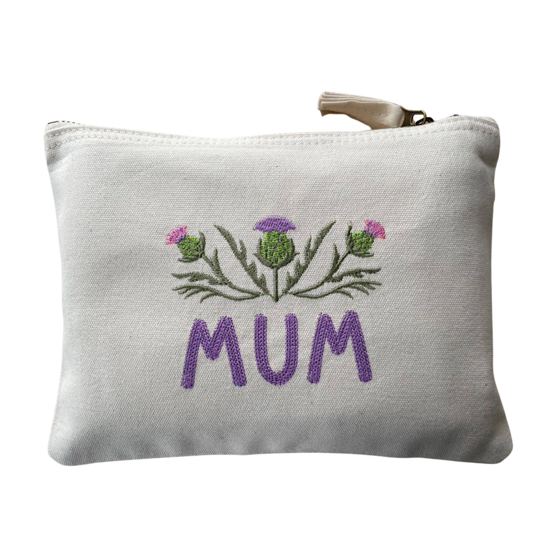 White Custom Scottish Thistle Gift Zipper Pouch with 'MUM' embroidery. An ideal Scottish thistle gift for mothers.