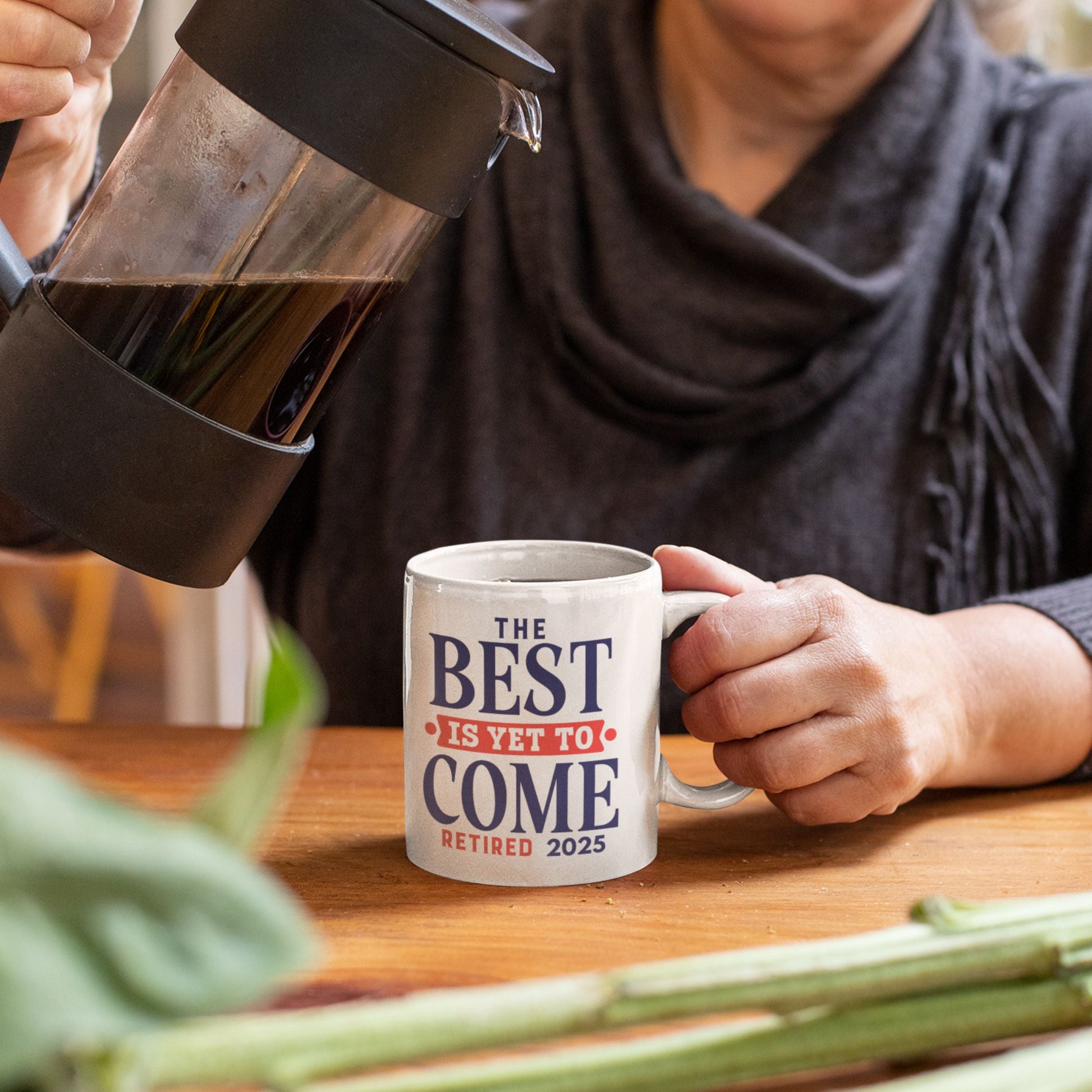 Happy Retirement Coffee Mug 2025 in hands of a woman, displaying 'The Best Is Yet To Come Retired 2025' - a delightful retirement coffee mug gift.