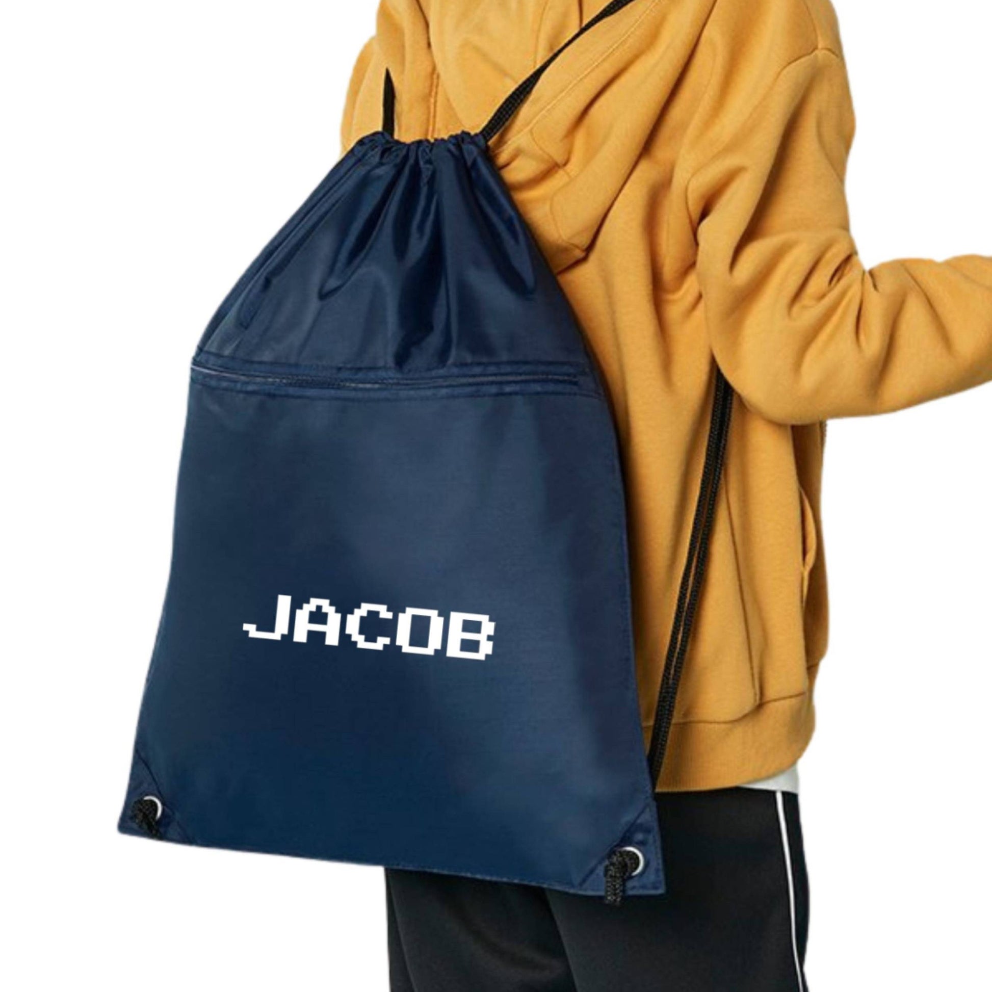Navy drawstring bag with 'JACOB' branding on a person wearing a mustard yellow jacket.