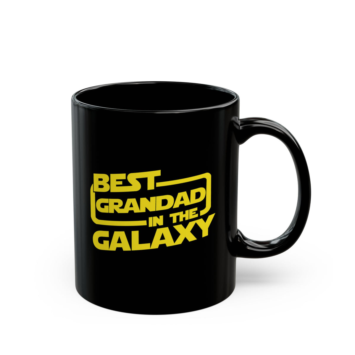 A glossy black ceramic mug with a yellow printed text design reading 'BEST GRANDAD IN THE GALAXY' in a Star Wars-style font, shown on a clean white background.