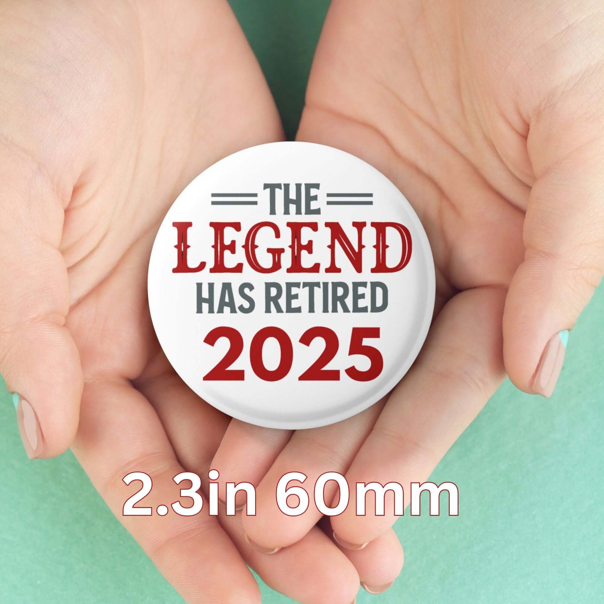 EMUWORKS 60mm retirement badge reading 'The Legend Has Retired 2025' held in hands.