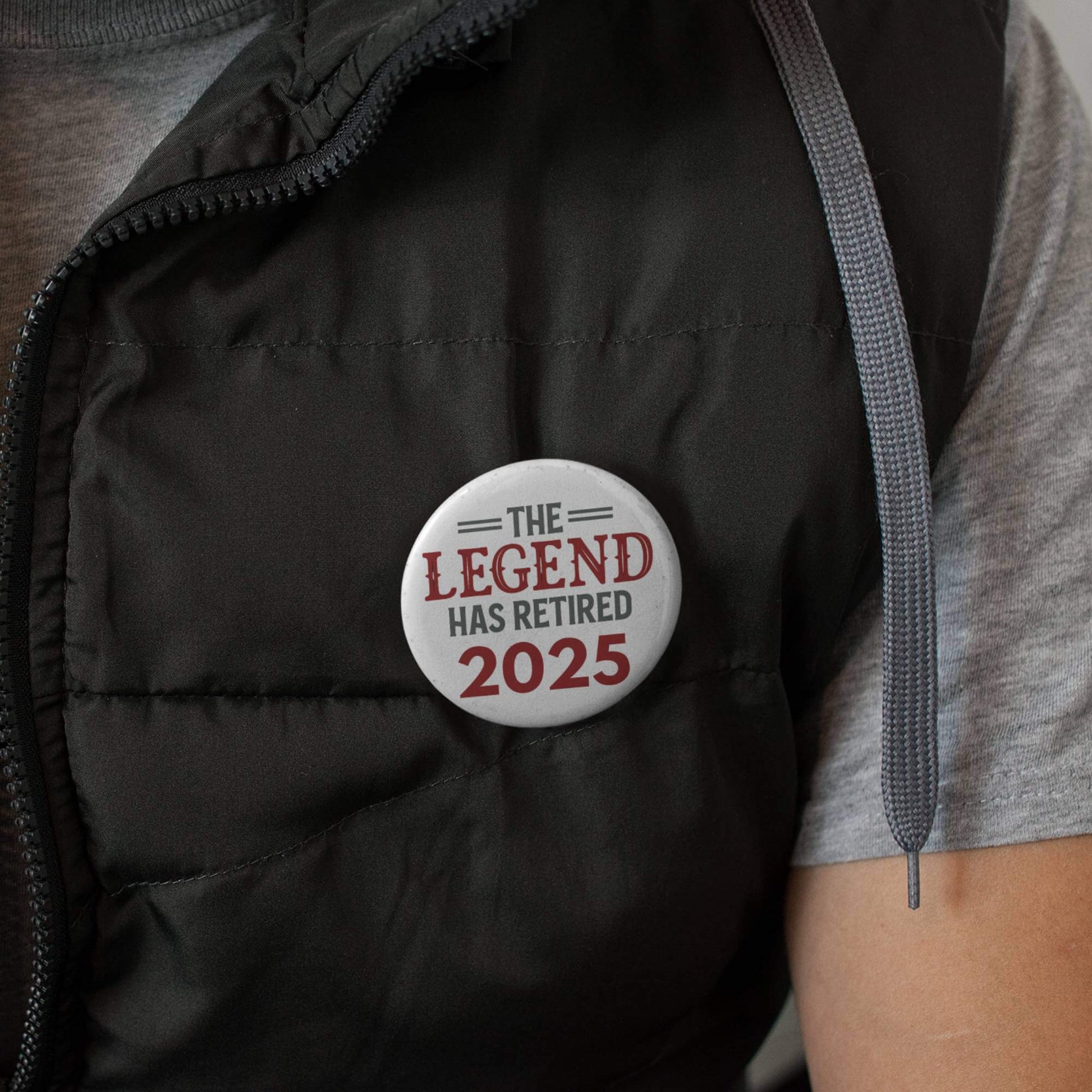 Close-up of EMUWORKS Retirement Badge 'The Legend Has Retired 2025' on a vest, celebrating retirement in style.