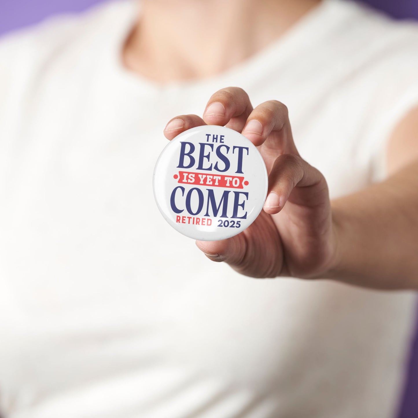 Person holding the Happy Retirement Party Pin while wearing a casual outfit. A delightful retirement party pin that adds joy to the occasion.