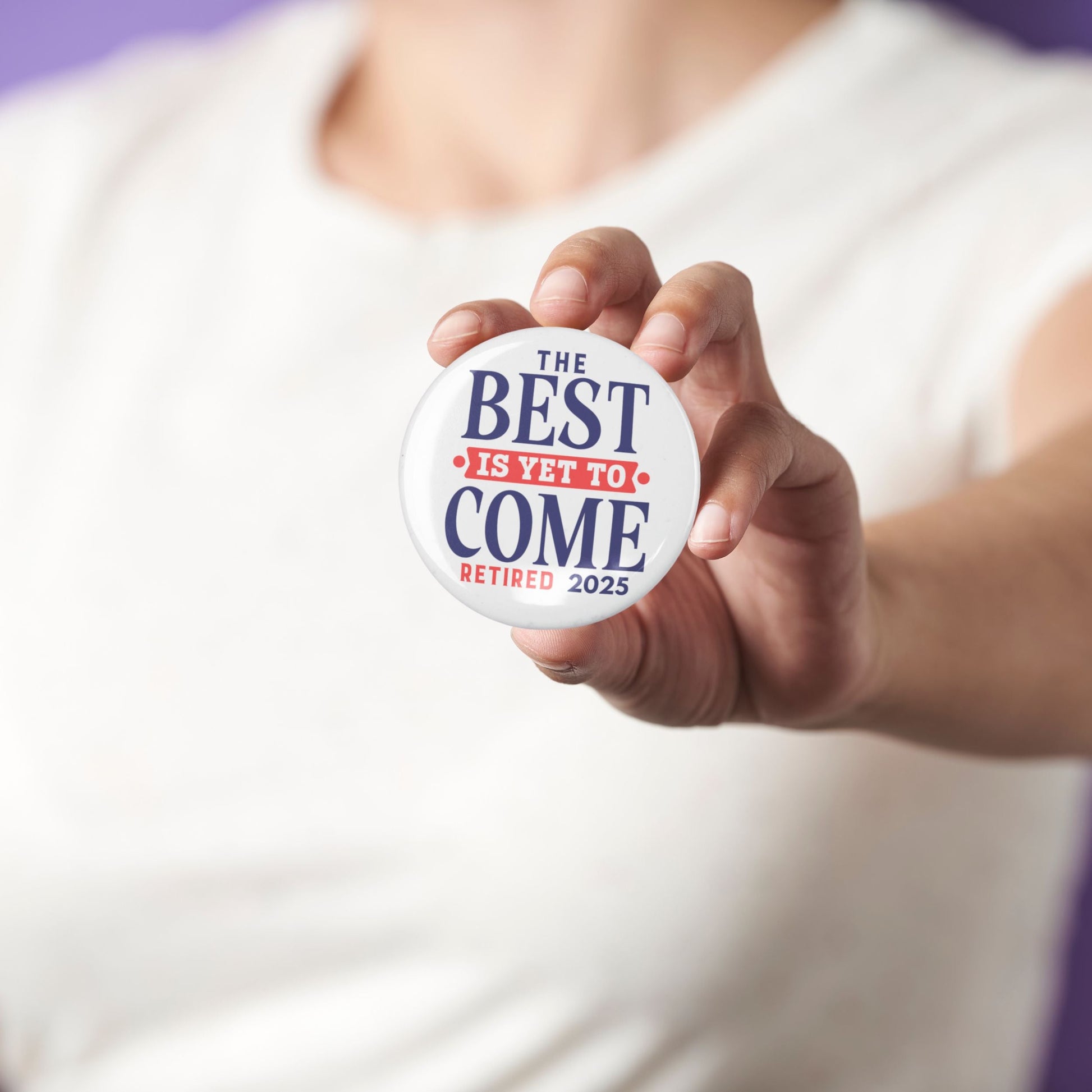 Person holding the Happy Retirement Party Pin while wearing a casual outfit. A delightful retirement party pin that adds joy to the occasion.